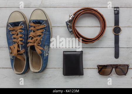 Flat lay of essential items for prepare to travel background concept.Mix variety object on modern rustic white wood home office desk.Accessory for tra Stock Photo