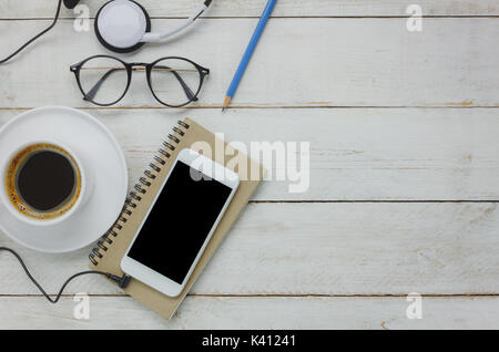 Table top view of technology on business desk background concept.Mix variety items on modern white rustic wood office with copy space.Essential access Stock Photo