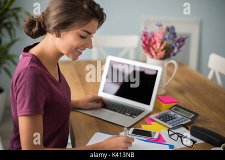 Busy woman taking some important notes Stock Photo