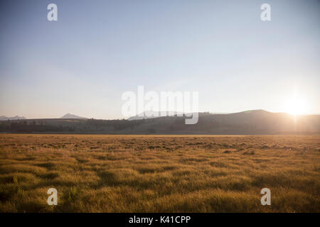 Beautiful sunset with sunrays behind the clouds Stock Photo