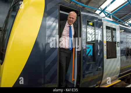 transport Secretary Chris Grayling looks out of South Western Railway's first fully-liveried Class 444 train after it arrived into the former international terminal at Waterloo station in central London. Stock Photo