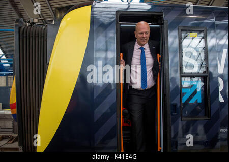 Transport Secretary Chris Grayling looks out of South Western Railway's first fully-liveried Class 444 train after it arrived into the former international terminal at Waterloo station in central London. Stock Photo