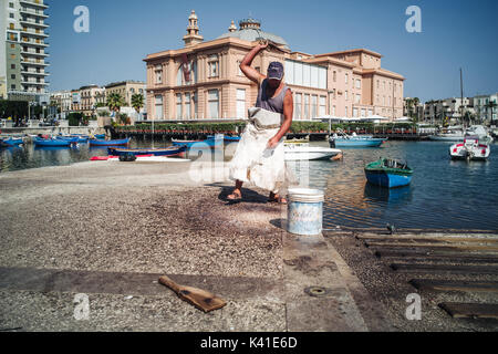 Daily life of fishermen in the old harbor of Bari, Puglia, south of Italy Stock Photo