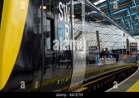 South Western Railway's first fully-liveried Class 444 train arrives into the former international terminal at Waterloo station in central London as the train operating company launches its new brand. Stock Photo