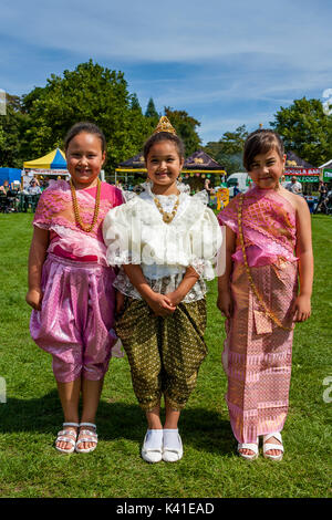 Three Anglo-Thai Children Dressed In Traditional Thai Costume, Brighton Thai Festival, Brighton, Sussex, UK Stock Photo