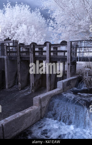 Infrared picture of the sluice gates on the River Tone at Firepool Lock in the centre of Taunton, Somerset Stock Photo