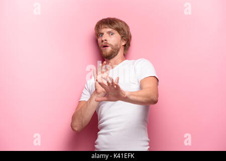 Crazy desperate good-looking man being shocked looking at camera with wide opened mouth Stock Photo