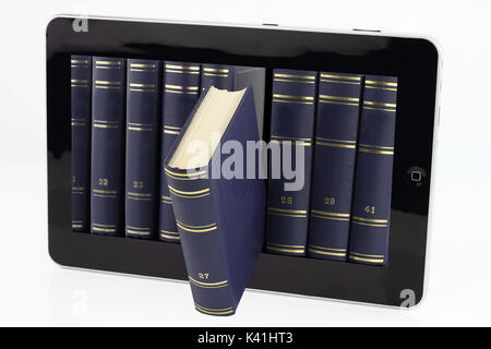 Tablet computer with books isolated on white Stock Photo