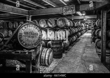 Black and white image of whisky maturing in barrels at the renowned Laphroaig Distillery, Isle of Islay, Scotland Stock Photo