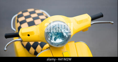 old scooter yellow on the background of asphalt. Taxi Stock Photo