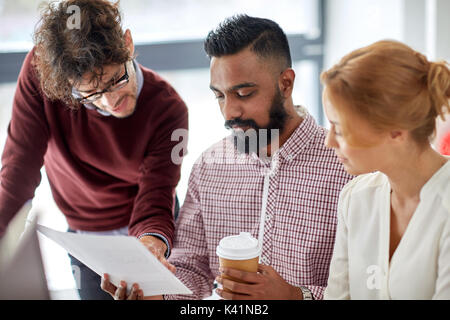 business team with papers and coffee at office Stock Photo