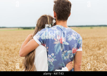 smiling young hippie couple over minivan car Stock Photo