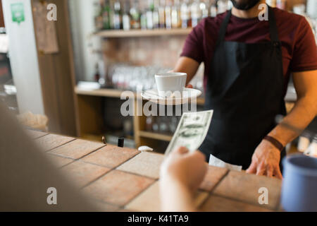 man or bartender serving customer at coffee shop Stock Photo