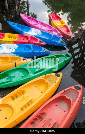 Group of colorful fiberglass kayaks on water in Thailand Stock Photo