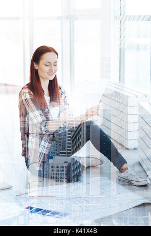 Pretty young woman holding a document in her hands Stock Photo