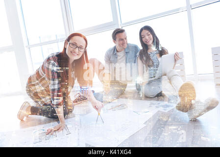 Smiling young engineer working with measurement tool Stock Photo