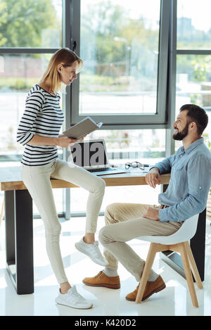 Cheerful colleagues chatting in the office Stock Photo
