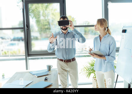 Bearded young man wearing VR headset in the office Stock Photo
