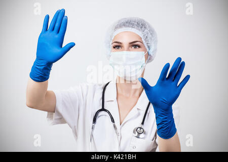 Woman doctor reaching for something in the air. Stock Photo