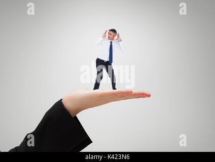 Digital composite of Small business man standing on the big business woman hand Stock Photo