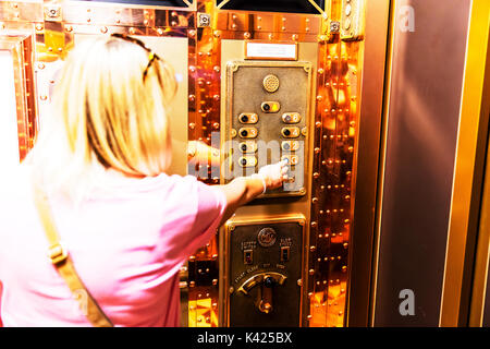Pressing button in elevator, using elevator, selecting floor number in elevator, using lift, pressing button in lift, elevator, lift, choosing lift no Stock Photo
