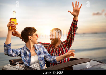 happy friends enjoying on road trip in their cabriolet Stock Photo