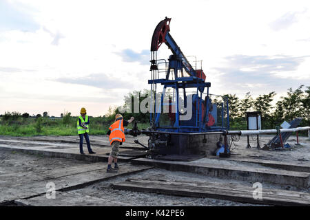 Two petroleum engineers at work on an European oil well Stock Photo