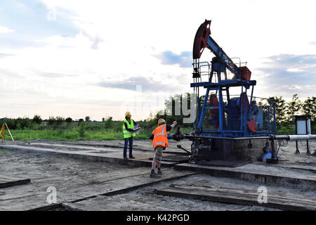 Two petroleum engineers at work on an European oil well Stock Photo