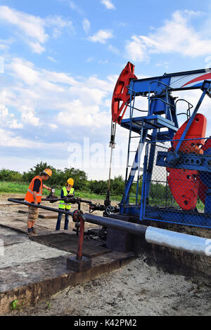 Two petroleum engineers at work on an European oil well Stock Photo