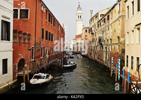 A typical Venetian canal, with Venetian architecture on both sides reflecting in the canal's water's. Venice, Italy Stock Photo