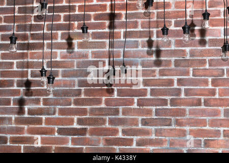 Brick wall with bulb lights lamp. nice brick show room with spotlights. Stock Photo