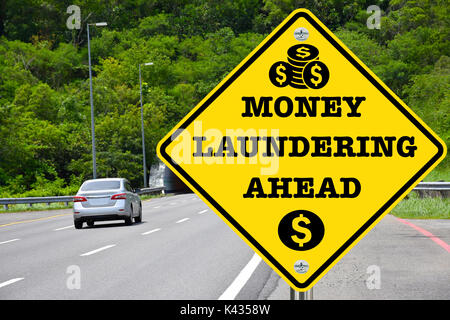 Money laundering ahead, yellow warning road sign Stock Photo