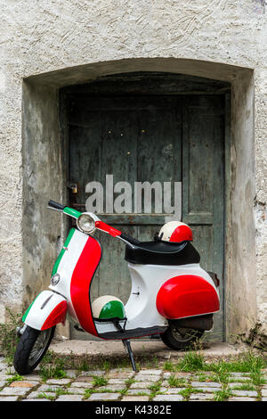 Parked Vespa scooter painted in Italian flag colors, Rome, Lazio, Italy Stock Photo