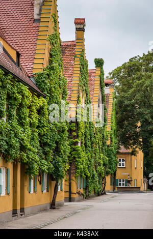 Street view of the Fuggerei settlement, the world's oldest social housing complex still in use, Augsburg, Bavaria, Germany Stock Photo