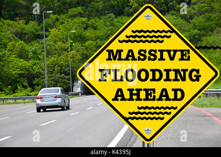 Massive Flooding Ahead yellow warning street sign Stock Photo