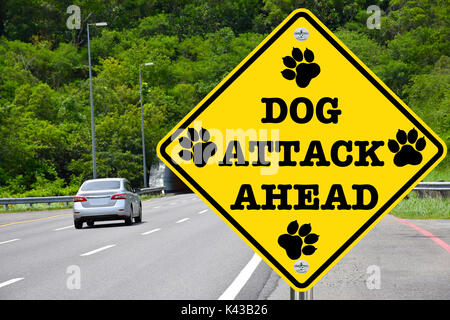 Dog attack ahead warning road sign Stock Photo