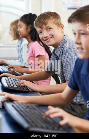 Portrait Of Male Elementary Pupil In Computer Class Stock Photo