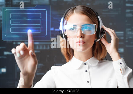Young businesswoman working in virtual glasses, select the icon on the virtual display Stock Photo