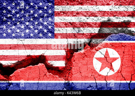 Flag of USA and North Korea on a cracked background. Concept of conflict between two nations, Washington and Pyongyang. Stock Photo