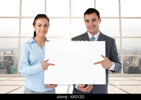 Digital composite of Business people holding blank card in office Stock Photo