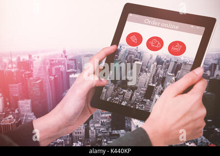 Cropped image of businesswoman holding digital tablet against image of a city landscape Stock Photo