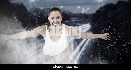 Woman bending with arms outstretched against splashing of dust powder Stock Photo