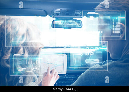 Business interface against couple using tablet computer in car Stock Photo