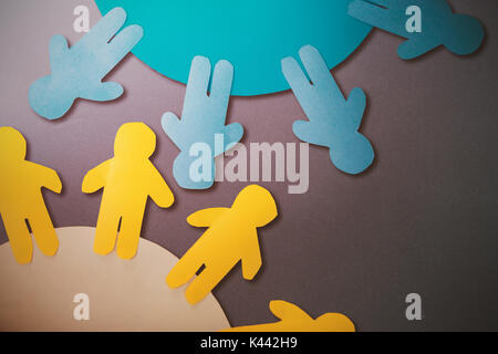 Yellow and blue little person on circle  against grey background Stock Photo