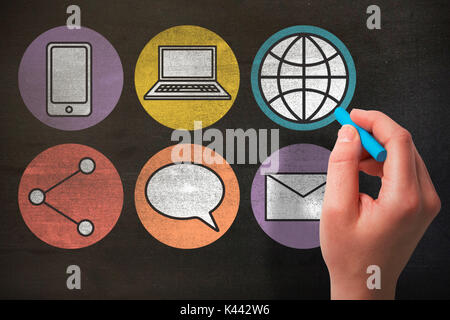 Hand holding blue chalk against black Stock Photo