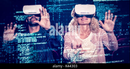 Image of data against couple using virtual reality headset Stock Photo