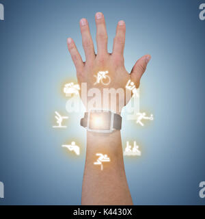 Cropped hand of man wearing smart watch against purple vignette Stock Photo