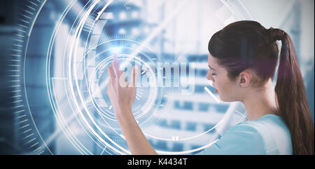 Young woman using imaginative digital screen against circle interface with percentage in blue background Stock Photo