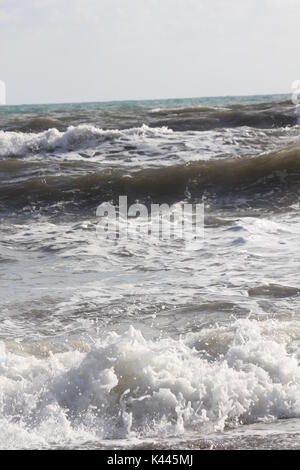 MARINA DI MASSA, ITALY - AUGUST 17 2015: Rough seas in Marina di Massa, Versilia, Italy Stock Photo