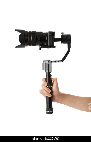 3-axis gimbals Stabilization System with Mirrorless Camera. Using this equipment, a Videographer can take video without shaking. Stock Photo